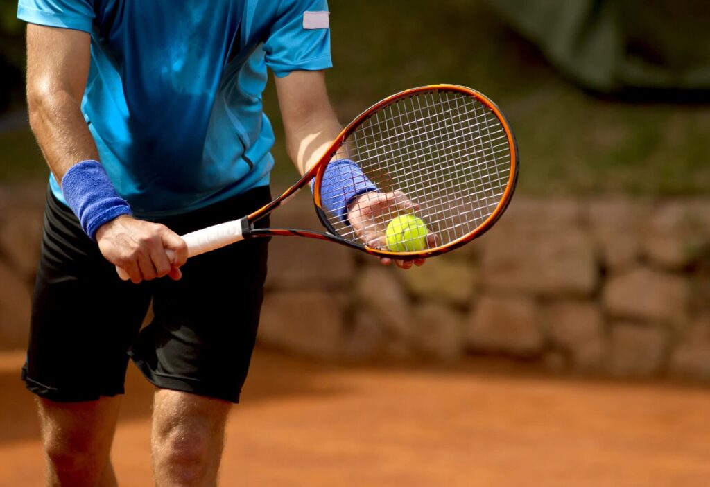 man holding tennis racquet.