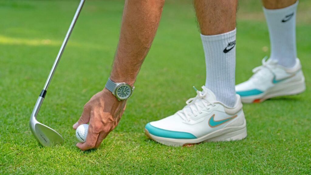man wearing golf shoes
