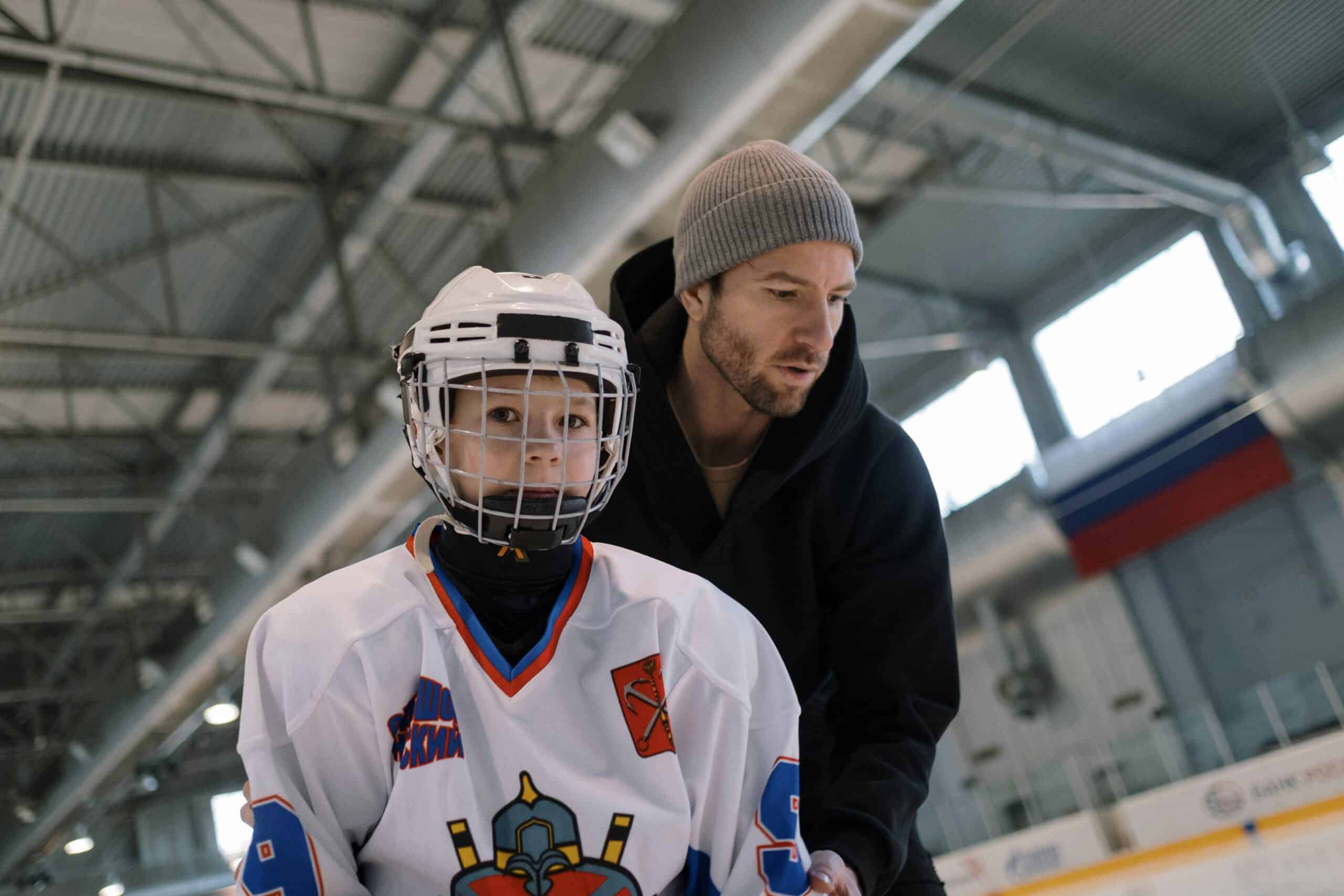 dad with son teaching hockey